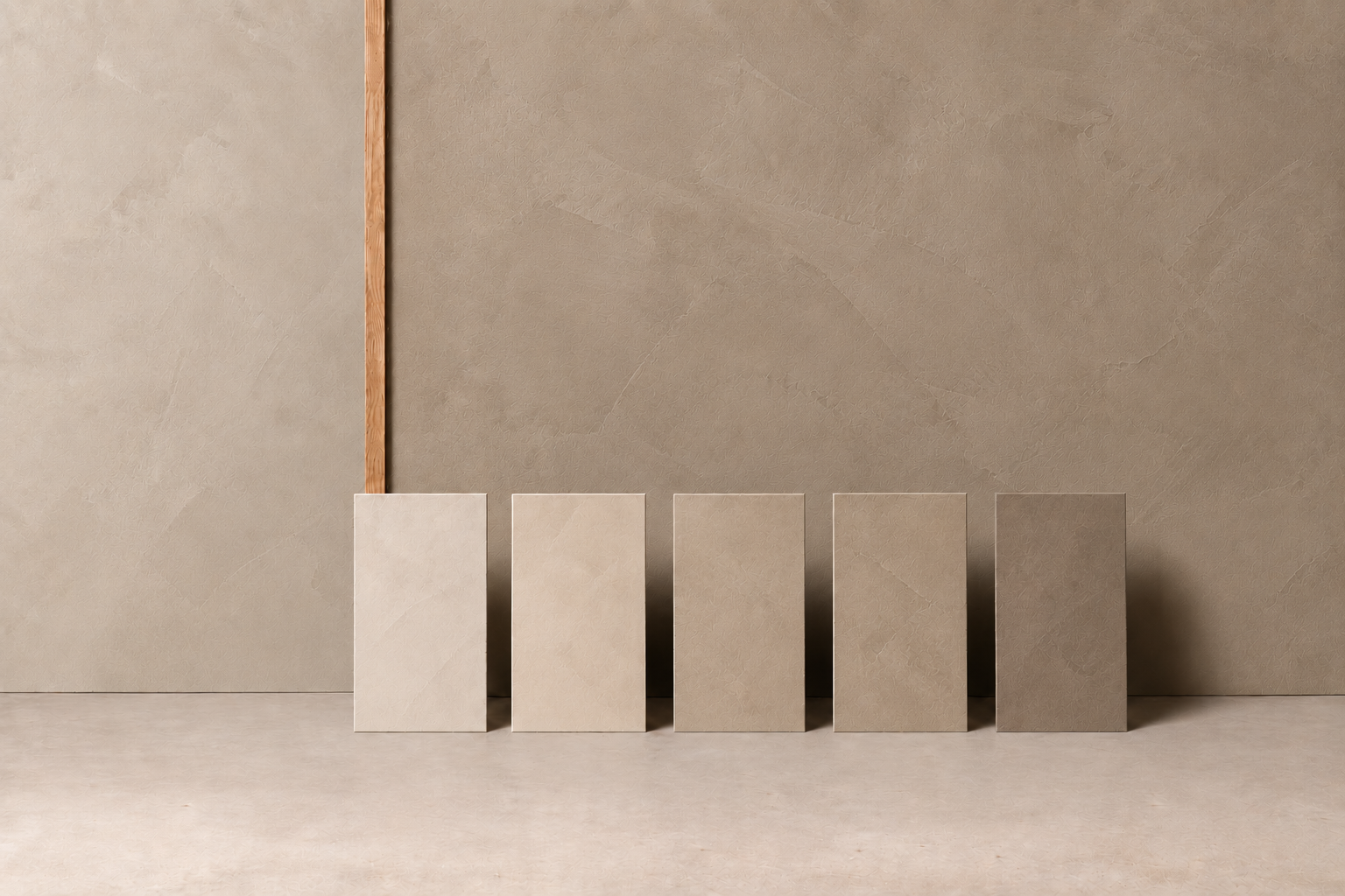 Five Limetech samples in sand and stone tones against a mineral lime wall.